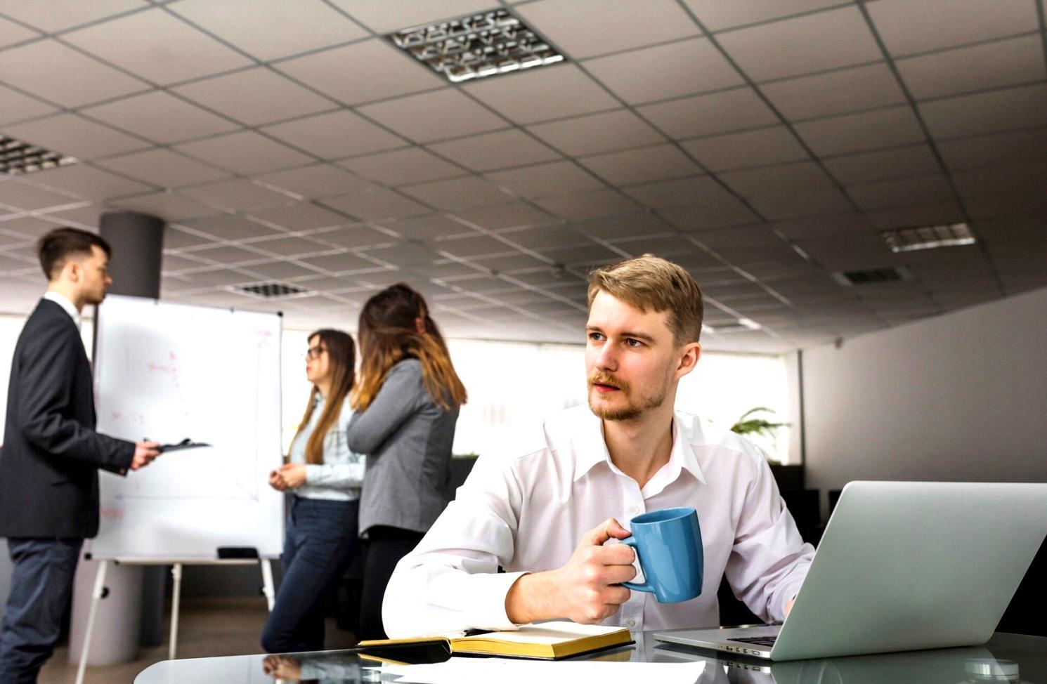 Person reviewing financial documents at desk with natural lighting